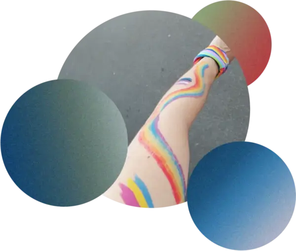 Rainbow-painted arm with pride bracelet in colorful bubbles